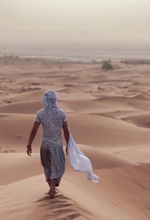 Guía caminando por la cresta de una duna